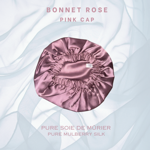 Magnifique bonnet de nuit en soie de mûrier rose apparaissant devant un voile transparent