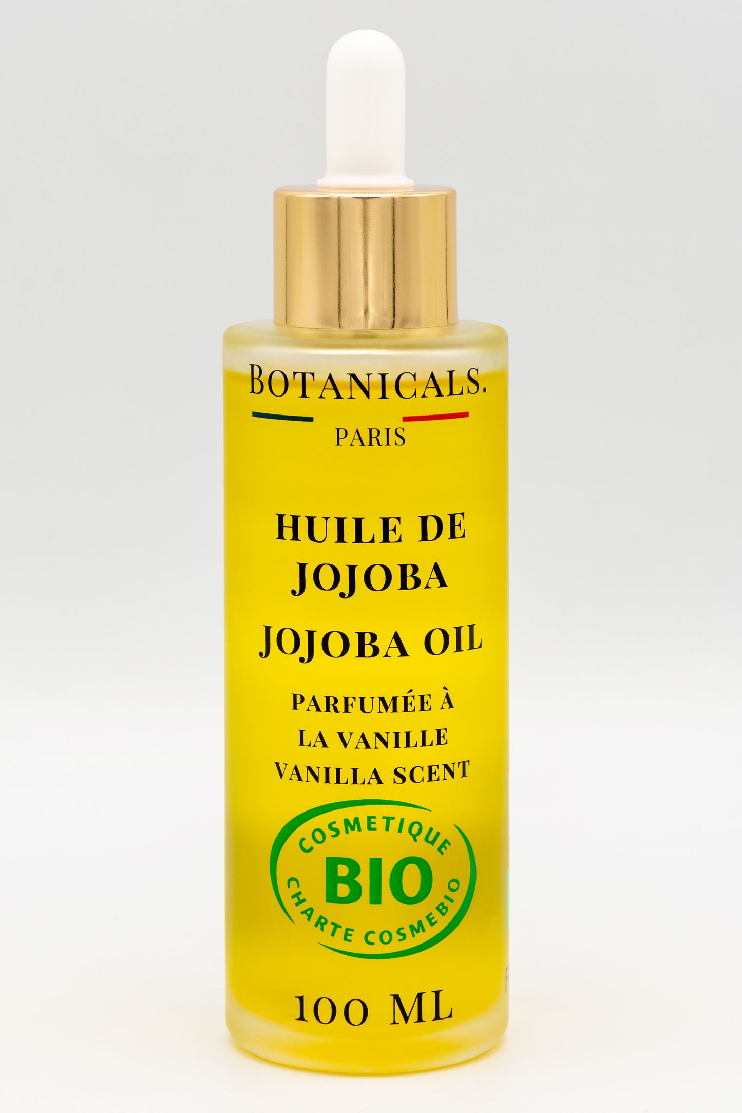 Une bouteille d'huile de jojoba bio 100ml Botanicals sur fond blanc