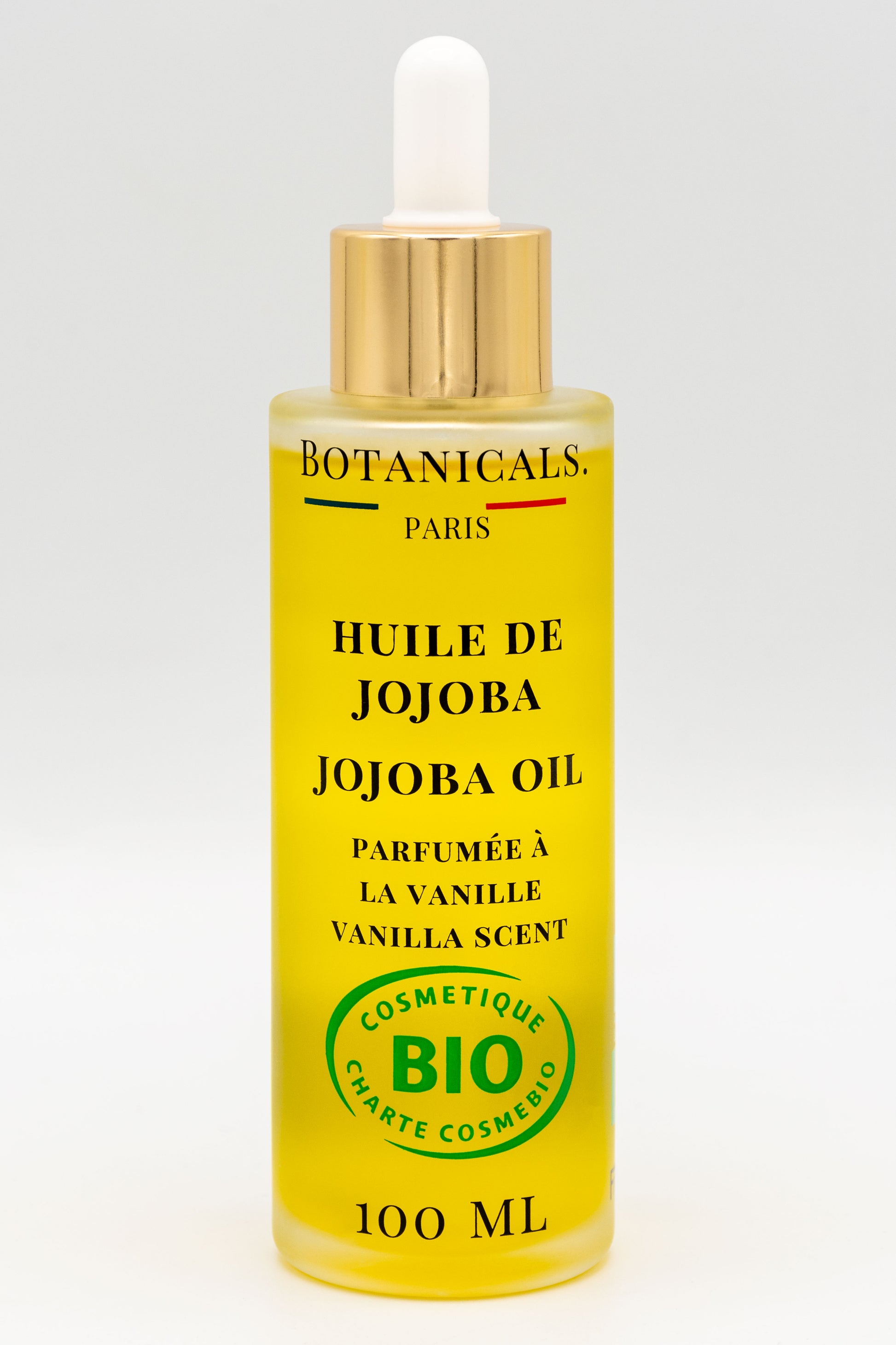 Une bouteille d'huile de jojoba bio 100ml Botanicals sur fond blanc