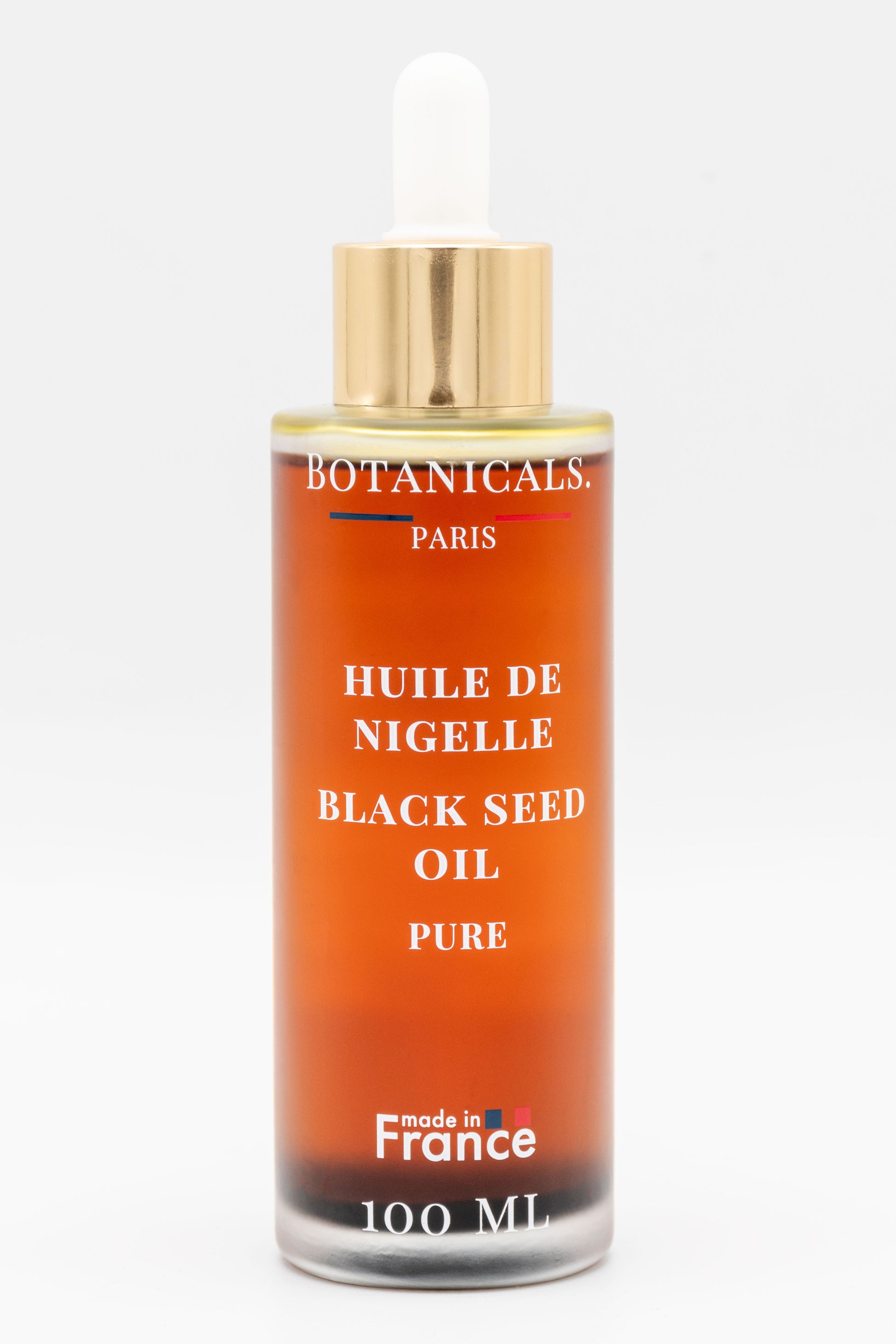 Une bouteille d'huile de nigelle bio 100ml Botanicals sur fond blanc