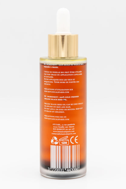 Une bouteille d'huile de nigelle bio 100ml Botanicals de dos sur fond blanc