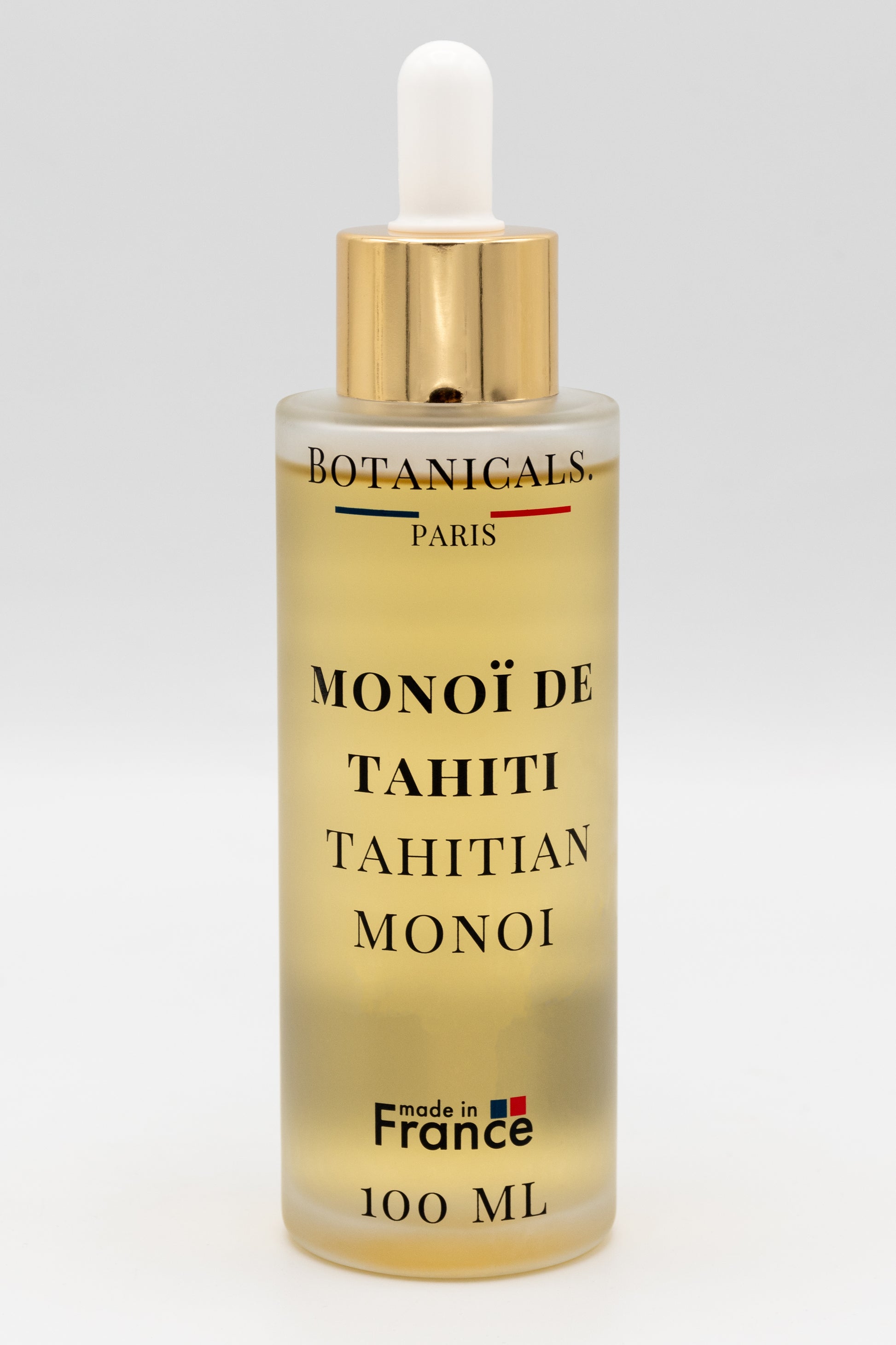 Une bouteille d'huile de monoï de Tahiti enrichi à l'huile de coco bio 100ml Botanicals sur fond blanc